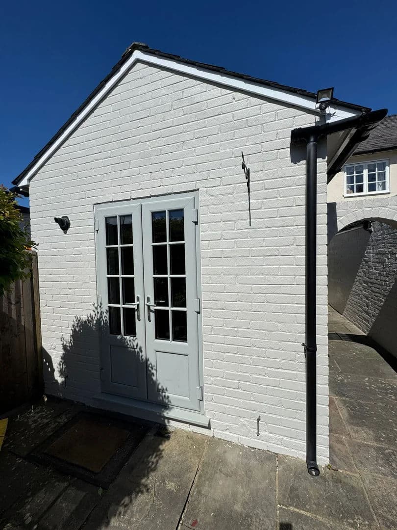 Outbuilding repainted in heritage white – after