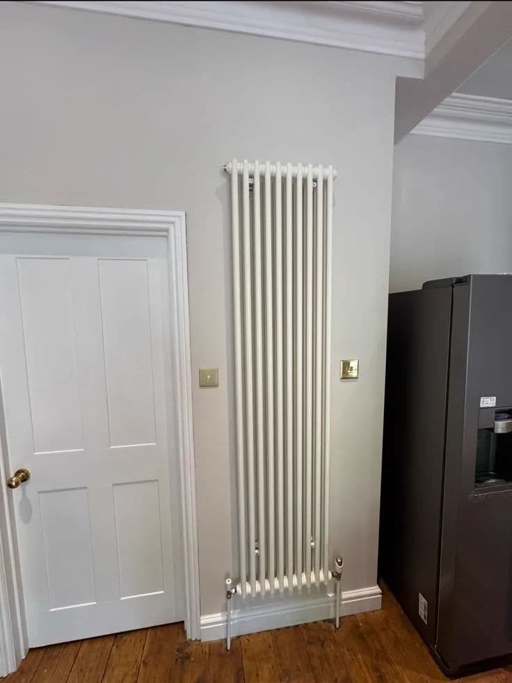 Wall repainted behind column radiator – after